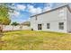 Large, grassy backyard enclosed by a white fence, offering privacy and space for outdoor activities at 1176 Epson Oaks Way, Orlando, FL 32837