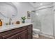 Bathroom with a modern vanity, a large mirror, and a glass enclosed shower at 1176 Epson Oaks Way, Orlando, FL 32837