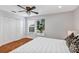 Bright bedroom offers ample closet space and a window for natural light with modern ceiling fan at 1176 Epson Oaks Way, Orlando, FL 32837