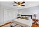 Bedroom with a ceiling fan, large double closet and a comfortable-looking queen sized bed at 1176 Epson Oaks Way, Orlando, FL 32837