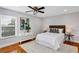 Cozy bedroom with stylish decor, including an abstract art piece and matching bedside tables at 1176 Epson Oaks Way, Orlando, FL 32837