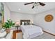 Comfortable bedroom featuring modern decor, a ceiling fan, and a large potted plant at 1176 Epson Oaks Way, Orlando, FL 32837