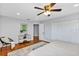 Brightly lit bedroom boasts modern decor, a ceiling fan and spacious closets for ample storage at 1176 Epson Oaks Way, Orlando, FL 32837