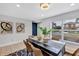 Open dining area with a large window, modern wall art, chandelier lighting, and comfortable seating at 1176 Epson Oaks Way, Orlando, FL 32837
