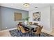 Modern dining room featuring a stylish chandelier, sophisticated wall decor, and a designer rug at 1176 Epson Oaks Way, Orlando, FL 32837