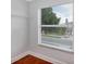 Bright empty room featuring a large window with blinds and a built in closet with a shelf at 1176 Epson Oaks Way, Orlando, FL 32837