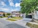 Charming two-story home with a gray exterior, a black garage door, and well-maintained landscaping at 1176 Epson Oaks Way, Orlando, FL 32837