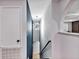 Well-lit hallway with stylish lighting and sleek black handrail showcases a contemporary and elegant design at 1176 Epson Oaks Way, Orlando, FL 32837
