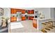 Spacious kitchen featuring stainless steel appliances, wooden cabinetry, a breakfast bar, and bright natural light at 1176 Epson Oaks Way, Orlando, FL 32837
