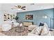 Inviting living room with a blue accent wall, modern furnishings, decorative lighting, and a comfortable seating area at 1176 Epson Oaks Way, Orlando, FL 32837