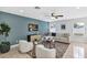 Cozy living room featuring modern furniture, a ceiling fan, stylish decor, and plenty of natural light at 1176 Epson Oaks Way, Orlando, FL 32837