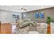 Open concept living room features a ceiling fan and stylish décor at 1176 Epson Oaks Way, Orlando, FL 32837