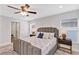 Spacious main bedroom featuring an area rug, neutral walls, recessed lighting, and two windows at 1176 Epson Oaks Way, Orlando, FL 32837