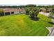 Wide shot of the backyard featuring lush green grass, and a screened lanai at 1306 Harbor Ridge Dr, Kissimmee, FL 34759