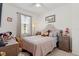Cozy bedroom with a tufted headboard, ample natural light, and charming decor, perfect for relaxation at 1306 Harbor Ridge Dr, Kissimmee, FL 34759