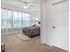 Bright bedroom with carpet floors, soft lighting, and large windows overlooking the landscaped yard at 1306 Harbor Ridge Dr, Kissimmee, FL 34759