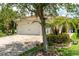 Charming home with a three car garage and brick paved driveway, surrounded by landscaping at 1306 Harbor Ridge Dr, Kissimmee, FL 34759