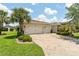 Charming single Gathering home with a three car garage and brick paved driveway at 1306 Harbor Ridge Dr, Kissimmee, FL 34759