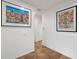 Bright hallway featuring beautiful artwork, tile floors, and a neutral color palette at 1306 Harbor Ridge Dr, Kissimmee, FL 34759