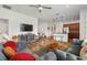 Spacious living room featuring tile floors, a modern ceiling fan, and seamless access to the kitchen at 1306 Harbor Ridge Dr, Kissimmee, FL 34759