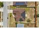 Top-down aerial view of a home equipped with solar panels, emphasizing energy efficiency at 131 Highland Meadows Pl, Davenport, FL 33837