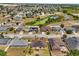 Aerial view showcases solar-paneled homes nestled in a suburban community with serene waterways at 131 Highland Meadows Pl, Davenport, FL 33837