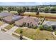 Aerial view of a home with solar panels in a well-maintained neighborhood, highlighting curb appeal at 131 Highland Meadows Pl, Davenport, FL 33837