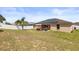 Expansive backyard featuring a solar-paneled home and a charming outdoor patio setup at 131 Highland Meadows Pl, Davenport, FL 33837