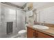 Bathroom featuring glass shower, framed mirror, cherry vanity, and updated fixtures at 131 Highland Meadows Pl, Davenport, FL 33837
