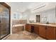 Bright bathroom features double sinks, large mirror, walk-in shower, soaking tub, and tiled accents at 131 Highland Meadows Pl, Davenport, FL 33837