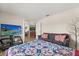 Comfortable bedroom featuring a cozy quilt, plush sofa, and a modern entertainment setup at 131 Highland Meadows Pl, Davenport, FL 33837