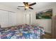 Spacious bedroom with ceiling fan, large bed, and a large TV for relaxing at 131 Highland Meadows Pl, Davenport, FL 33837