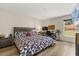 Comfortable bedroom features wood-look floors, a cozy bed, a desk and a large window at 131 Highland Meadows Pl, Davenport, FL 33837