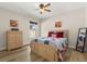 Bedroom featuring wood floors, neutral walls, ceiling fan, and large window at 131 Highland Meadows Pl, Davenport, FL 33837