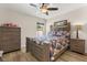 Bedroom featuring a bed with floral sheets, wood dresser, wood floors, and ceiling fan at 131 Highland Meadows Pl, Davenport, FL 33837