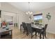 Elegant dining area featuring a dark wood table set for six, with views to another bedroom space at 131 Highland Meadows Pl, Davenport, FL 33837