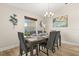 Formal dining room with a large table set for six, complemented by elegant decor at 131 Highland Meadows Pl, Davenport, FL 33837