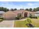 Charming single-story home with a well-manicured lawn and inviting front entrance at 131 Highland Meadows Pl, Davenport, FL 33837