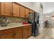 Spacious kitchen with rich wood cabinetry, granite countertops, and stainless steel appliances at 131 Highland Meadows Pl, Davenport, FL 33837
