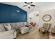 Cozy living room featuring vaulted ceiling, a large sectional sofa, and stylish decor at 131 Highland Meadows Pl, Davenport, FL 33837