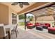 Inviting covered patio with outdoor dining and lounge area, perfect for entertaining at 131 Highland Meadows Pl, Davenport, FL 33837