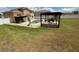 Large backyard with patio area, in-ground pool with slide, and a pergola covered dining area at 1505 Chevington Ct, Orlando, FL 32824
