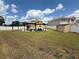 Spacious backyard with lush green grass, a shed, a pool with a slide, and an outdoor seating area at 1505 Chevington Ct, Orlando, FL 32824