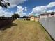Expansive backyard featuring a pergola, fence, and ample green space, perfect for outdoor activities and entertaining at 1505 Chevington Ct, Orlando, FL 32824