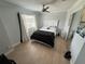 Cozy bedroom with neutral tones, a queen-size bed, ceiling fan, and mirrored closet at 1505 Chevington Ct, Orlando, FL 32824