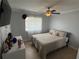 Serene bedroom with tiled floor, soft lighting, and a large window for natural light at 1505 Chevington Ct, Orlando, FL 32824