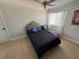 Bedroom featuring tiled floors, neutral walls and a queen bed with tufted headboard at 1505 Chevington Ct, Orlando, FL 32824