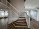 Foyer with wood flooring, white railings and banisters, and views into the living room and dining room at 1505 Chevington Ct, Orlando, FL 32824