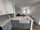 Modern kitchen with white cabinets, granite countertops, and view into the living area at 1505 Chevington Ct, Orlando, FL 32824