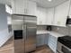 Bright kitchen featuring stainless steel refrigerator, gray backsplash and countertops, and stylish fixtures at 1505 Chevington Ct, Orlando, FL 32824
